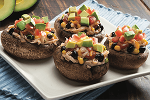 chicken enchilada stuffed mushrooms on a plate