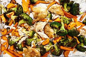 a sheet pan dinner with rotisserie chicken and vegetables