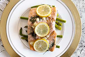 Lemon butter salmon with asparagus on a plate