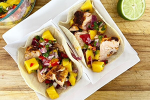 salmon tacos with mango salsa on a plate